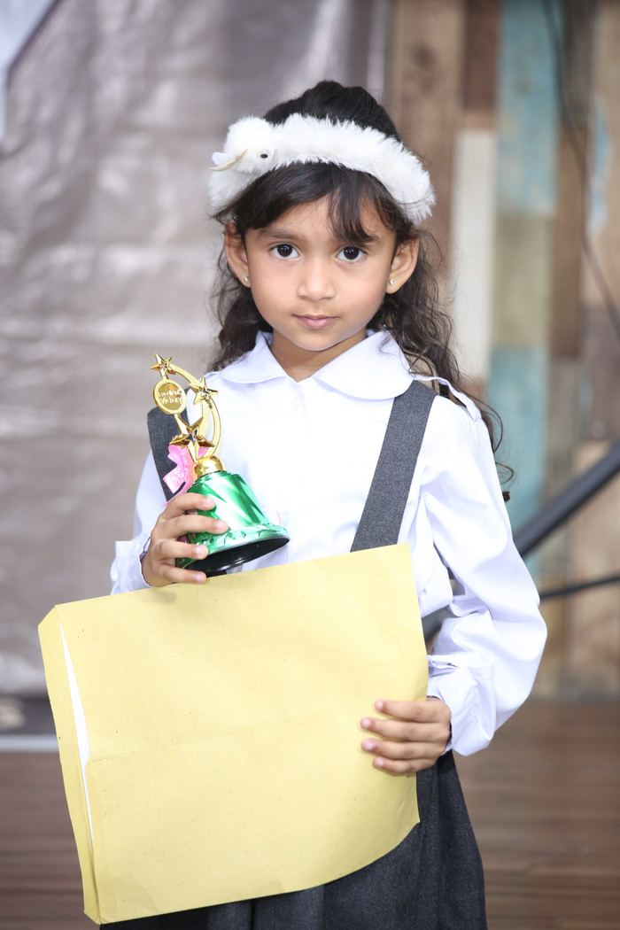 A young Maranatha pupil holding her prize