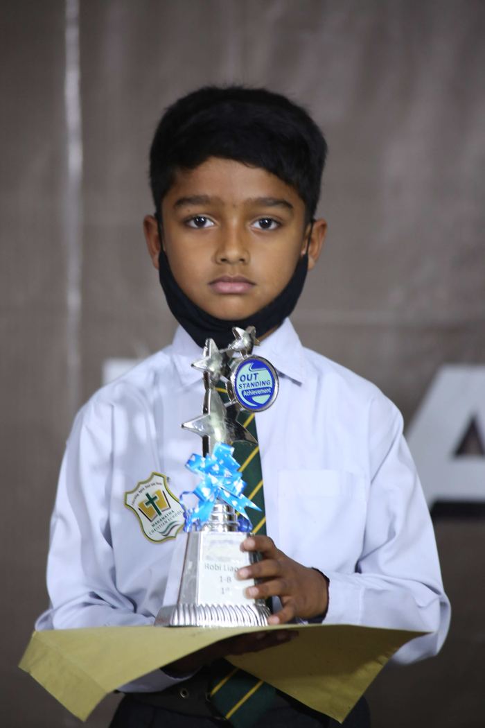 A Maranatha pupil holding a prize at the 2022 annual result