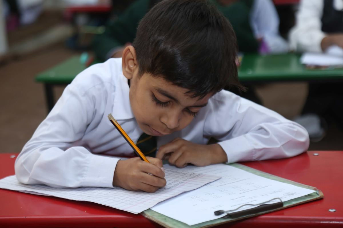 A Maranatha pupil writing carefully