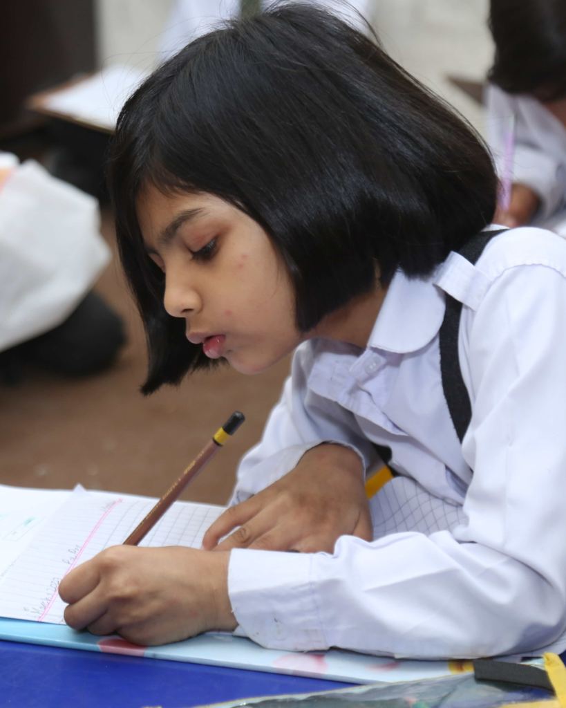 A pupil of Maranatha Christian School writing during a lesson